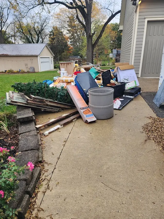 Dumpster being loaded with debris for Estate Cleanout Dumpster Rental in Hendersonville